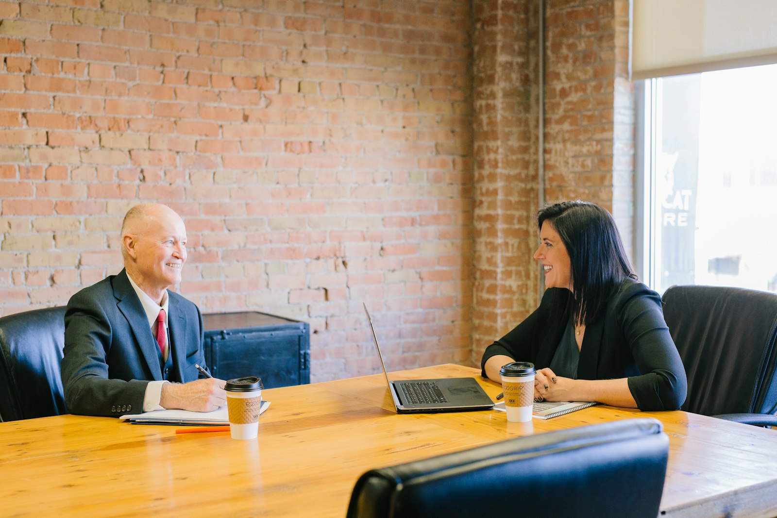 A licensed insurance agent sitting with a client and going through plan options
